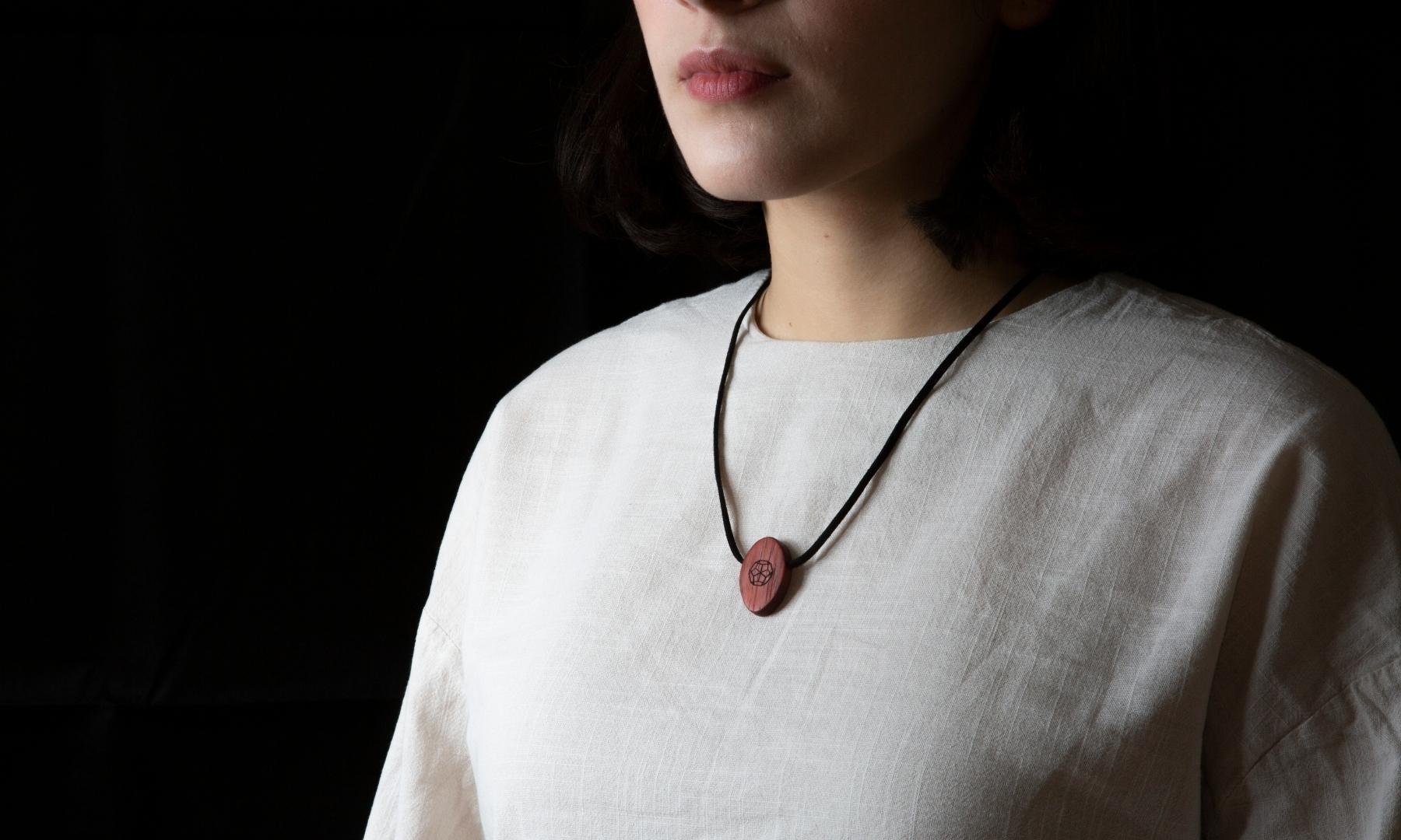 Padauk Deca Omnia Radiation Balancer Pendant on shirt