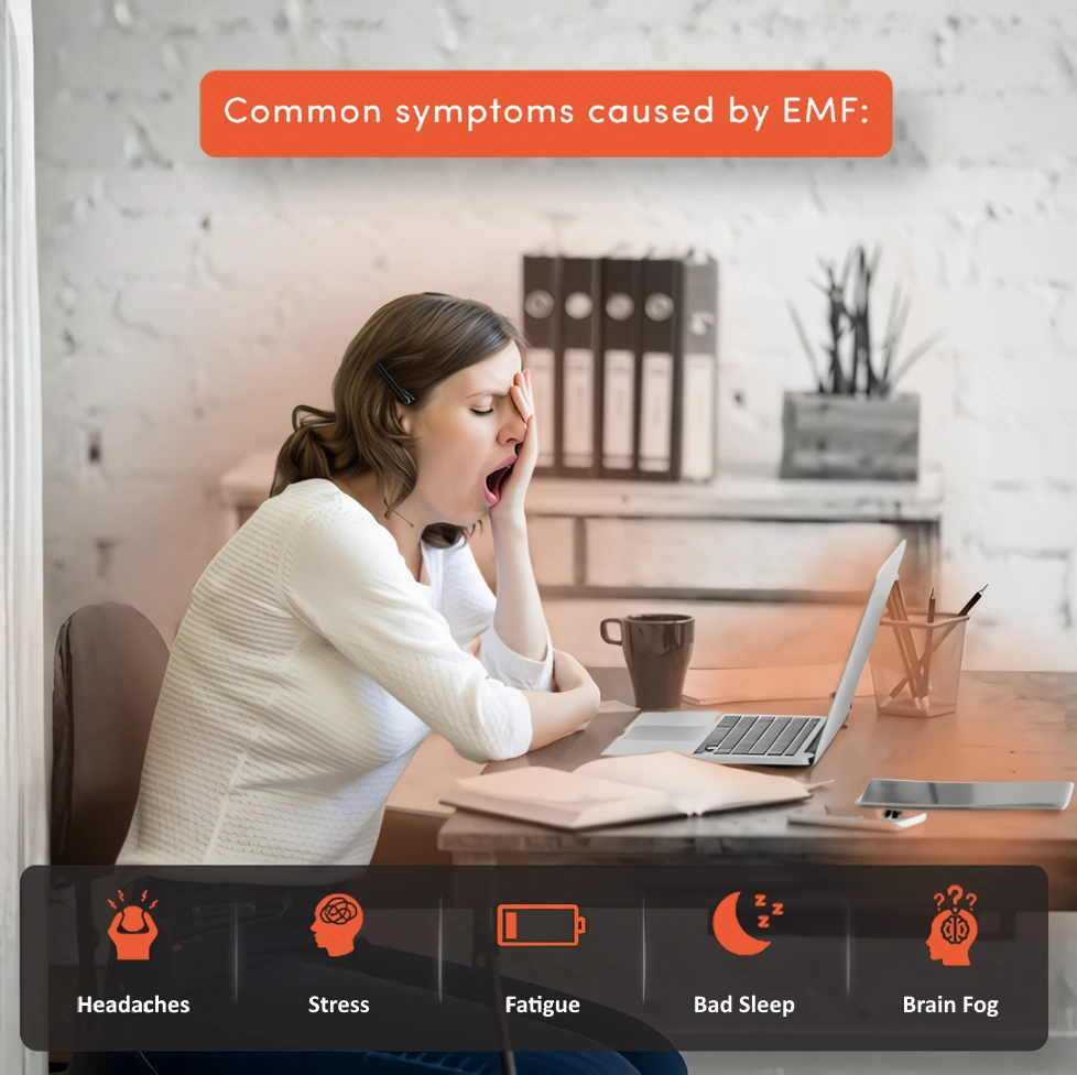 woman at desk with headache, stress, fatigue and brain fog caused by EMF exposure